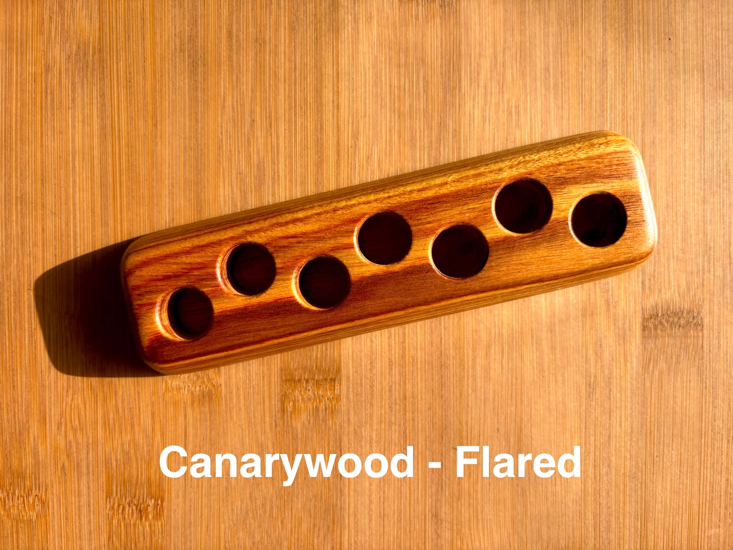 Canarywood ink sample vial holder with flared base, featuring warm golden and reddish grain tones
