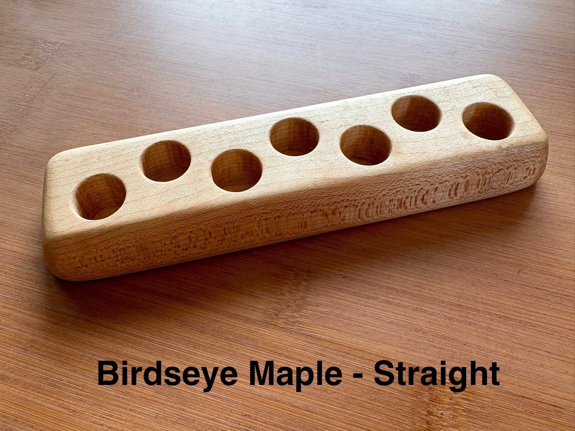 Straight-base birdseye maple ink sample vial holder with distinctive speckled grain pattern
