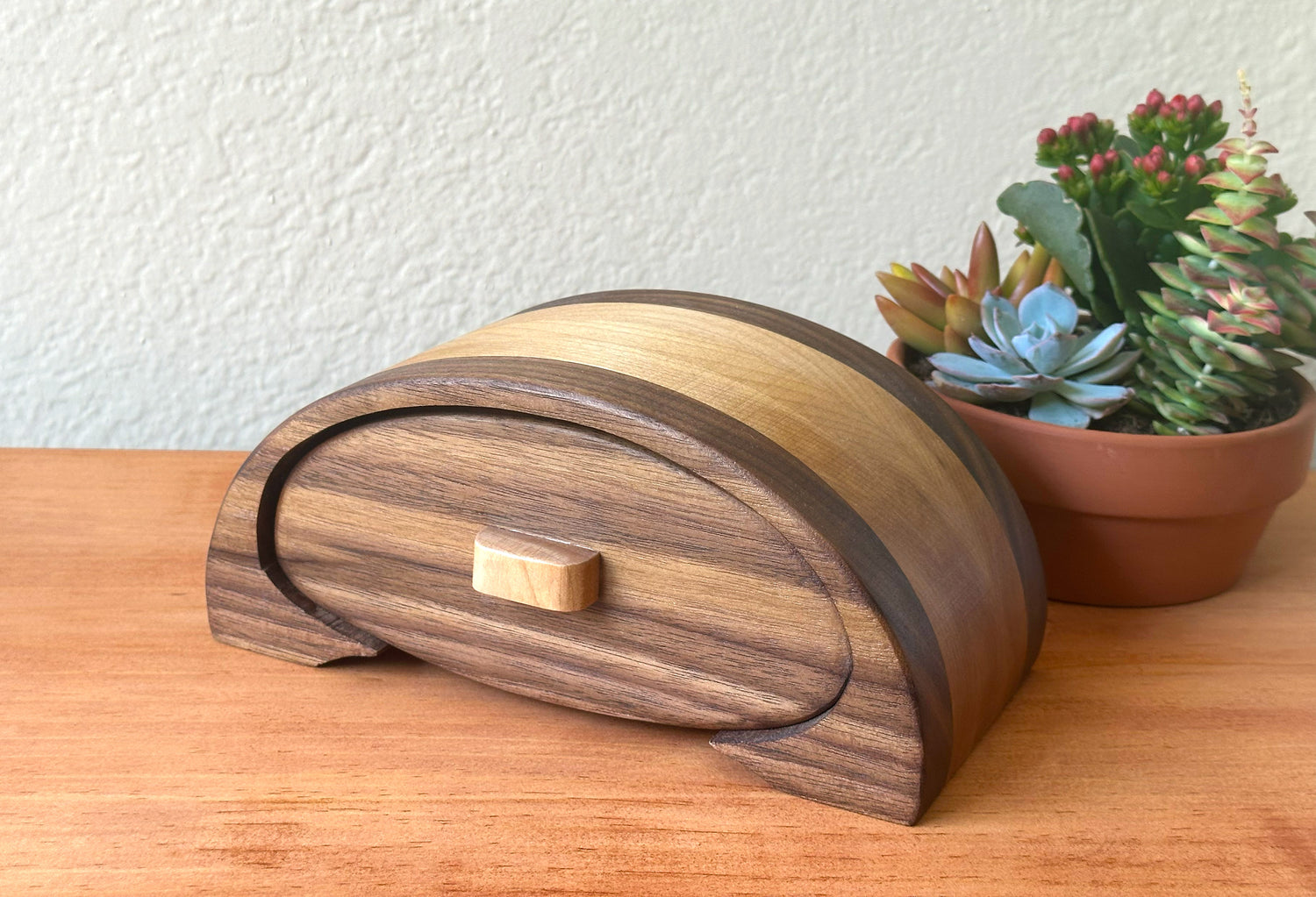 Custom handcrafted wooden box in walnut and maple, symbolizing Nagomi’s personalized approach to peaceful design